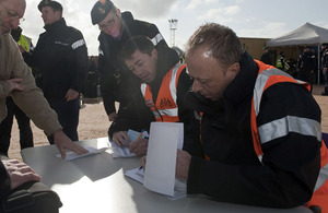 Britons and entitled persons are processed for transit to Malta aboard HMS Cumberland at the port of Benghazi in Libya