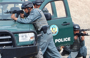 British-trained Afghan National Policemen poised to engage the enemy from their patrol vehicle