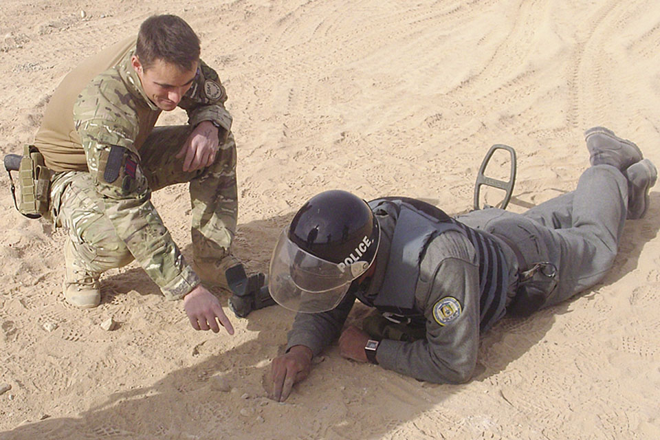 British Army mentor instructs an Afghan National Police recruit during a counter-improvised explosive device course in Helmand province