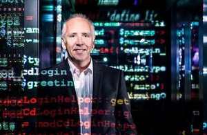 Dr Godfrey Gaston, director of the Centre for Secure Information Technologies at Queen's University Belfast, with digital text projected on to him