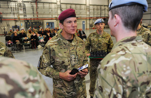 Colonel Jacko Jackson presents soldiers with campaign medals