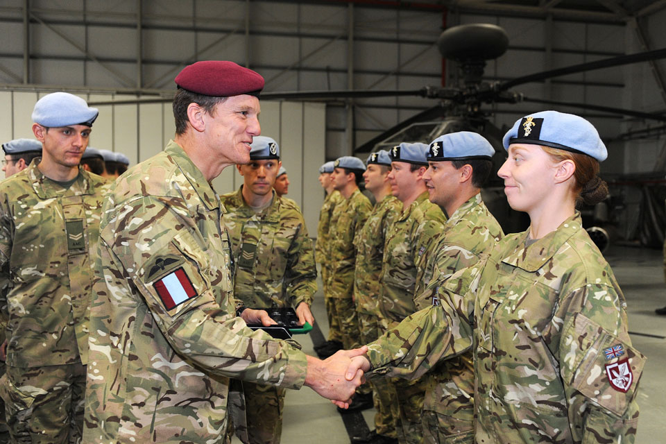 Colonel Jacko Jackson presents soldiers with campaign medals