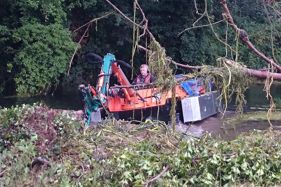 Amphibious weed cutting boat