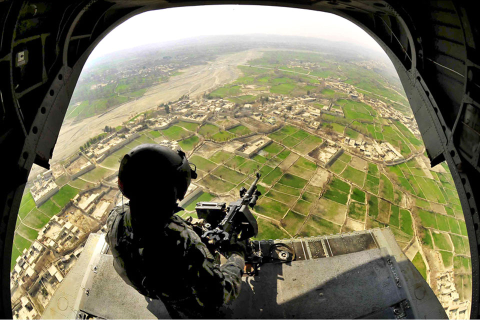 Sergeant 1st Class James Lee provides aerial security from the rear door of a CH-47 Chinook helicopter over Kandahar province 