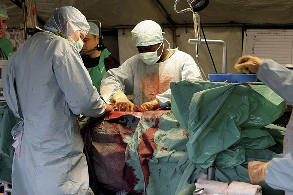Military medics at work in a front line hospital operating theatre (stock image) 