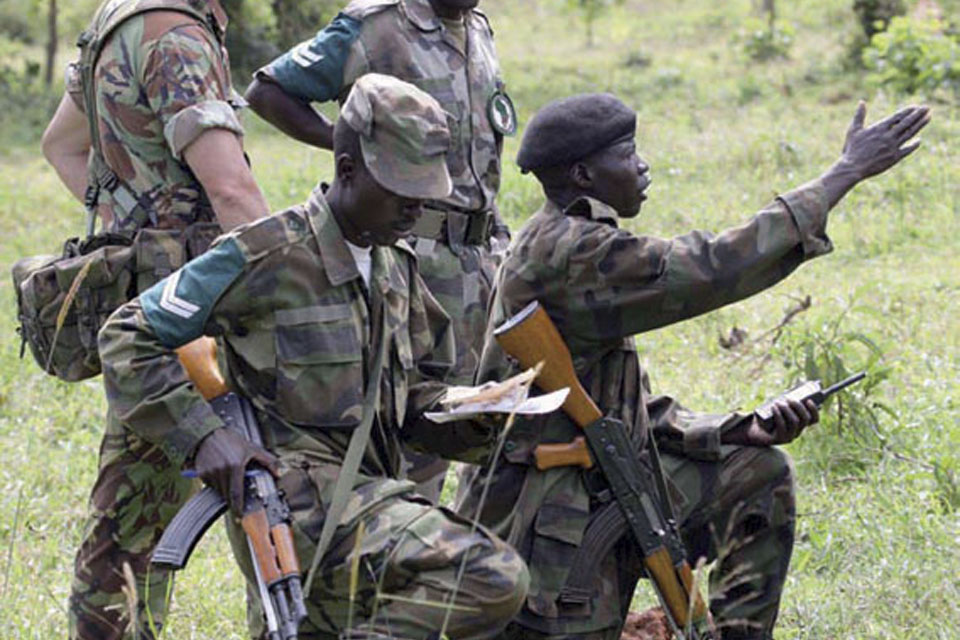 A British Army mentor supervises soldiers from the Uganda People's Defence Force as they practise their skills  