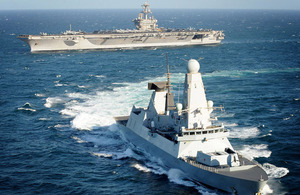 HMS Daring with United States Navy Nimitz Class aircraft carrier the USS Carl Vinson in the background