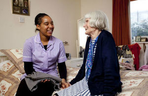 Healthcare worker assisting an older person.