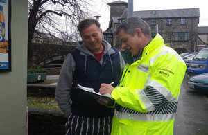 Community support officer talking to residents and businesses in Kendal