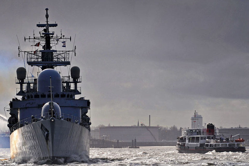 HMS Liverpool leaves Liverpool for the final time, firing a gun salute as she passes the Cammell Laird shipyard where she was built