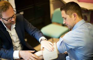 A GP measuring a patient's blood pressure