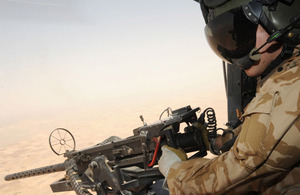 Lance Corporal Gary Lovett is in control of a .50 calibre heavy machine gun as a 'door gunner' in a Lynx Mark 9A helicopter