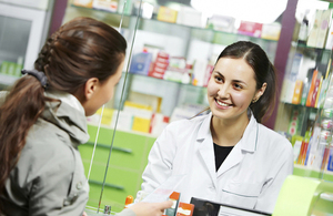 A pharmacist talking to a customer.