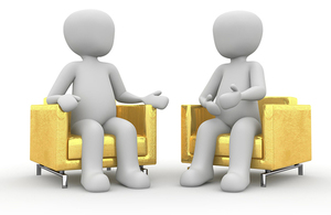 two animated cartoon people sat in yellow chairs