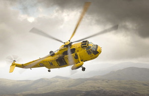 An iconic RAF Sea King Search And Rescue helicopter banks over Snowdonia, North Wales (stock image)