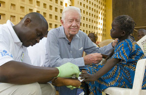 President Carter comforts 6 year old girl with guinea worm