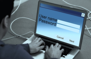 man logging into laptop: user name and password page on screen