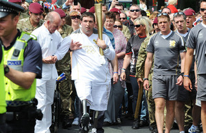 Lance Bombardier Ben Parkinson carries the Olympic Flame through Bennetthorpe in Doncaster