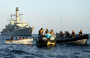 Royal Marines and sailors from HMS Montrose investigate a boat with suspected pirates onboard