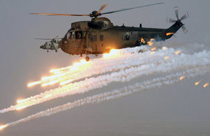 A Royal Navy Sea King Mk4 helicopter of the Commando Helicopter Force (CHF) fires decoy flares.