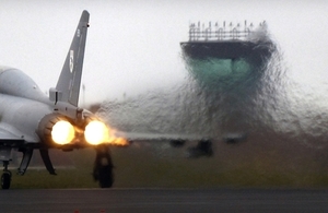 A F2 Typhoon takes off from RAF Coningsby, Lincolnshire creating a heat haze that stretches across the runway.