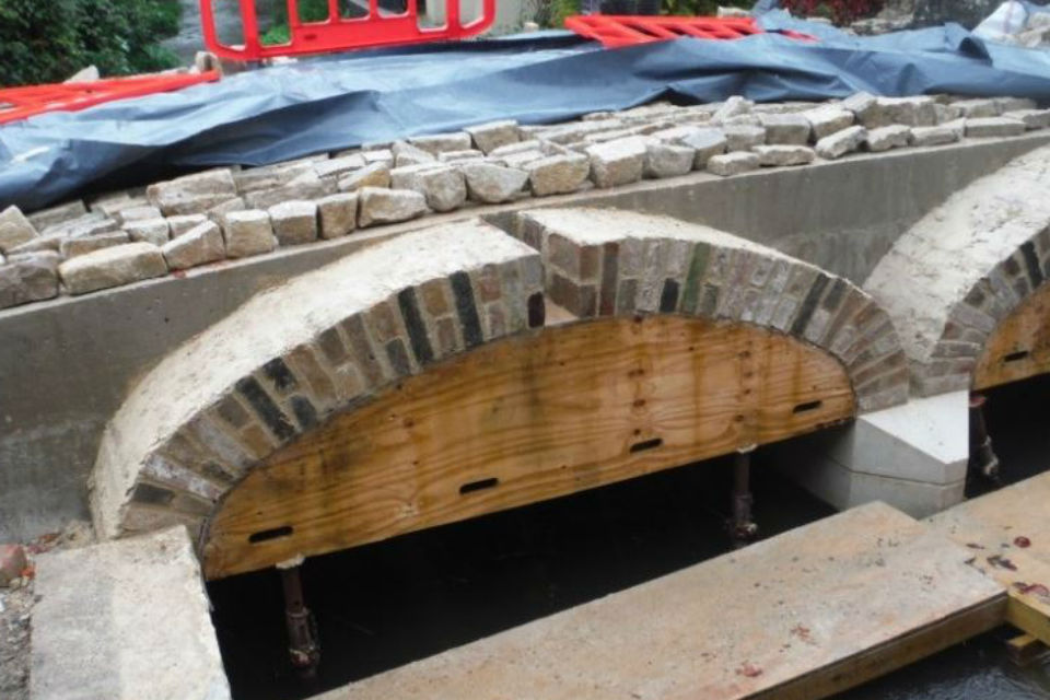 Stone from the original bridge being used to form the exposed barrel ends