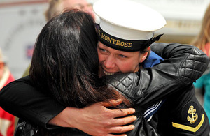 A sailor from HMS Montrose is welcomed home by a loved one in Plymouth