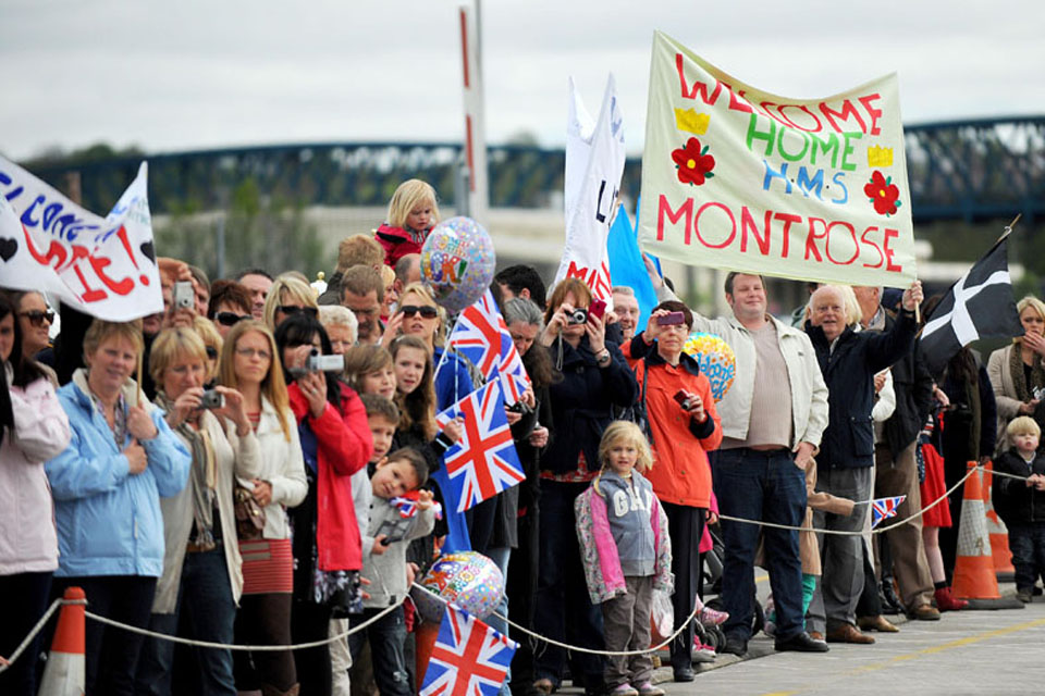 Crowds of families and friends await loved ones returning to Plymouth on board HMS Montrose