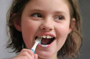 A girl brushing her teeth.