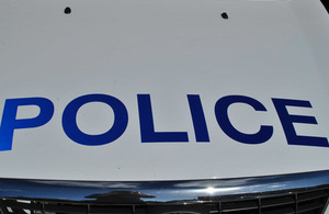 The front of a police car, showing the police logo