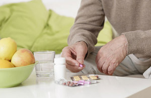 Elderly man with pills