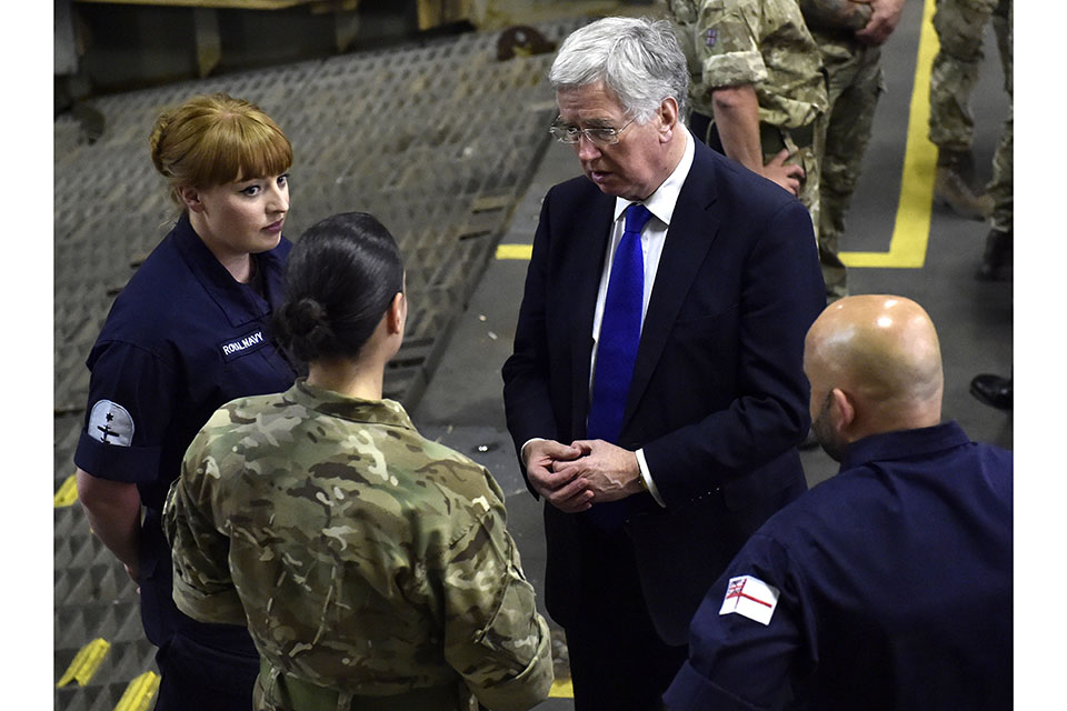 AET Kellaway, AET Bennett, Defence Secretary Michael Fallon and RPO Briant (L-R) talking on the vehicle deck of RFA Cardigan Bay. Crown Copyright. 