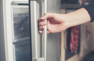 Opening a fridge.