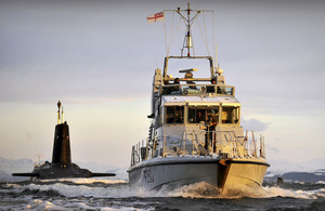 The Royal Navy P2000 patrol vessel HMS Dasher escorts nuclear submarine HMS Vanguard to her berth at HM Naval Base Clyde