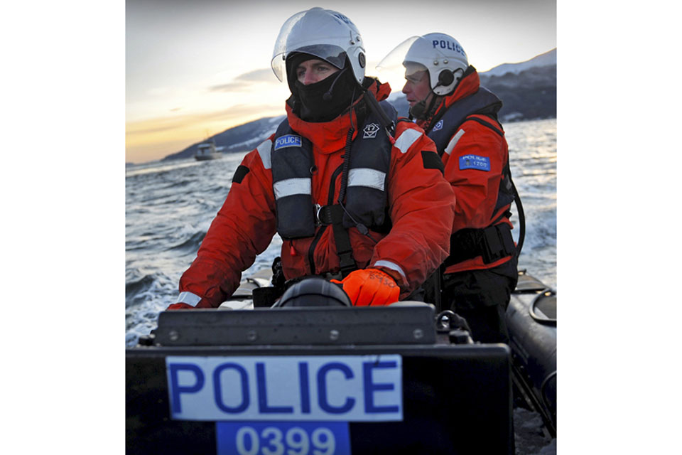 Members of Clyde Marine Police Unit escorting Royal Navy nuclear deterrent submarine HMS Vanguard back to HM Naval Base Clyde in Scotland (stock image)