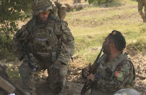 An Afghan warrior briefs a British soldier during Operation BIG FISH