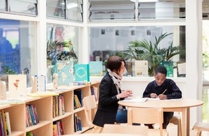 Image: adult and pupil around table