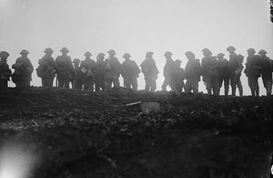 A long line of British reserve troops standing silhouetted against the dawn near Thiepval, 15th September 1916