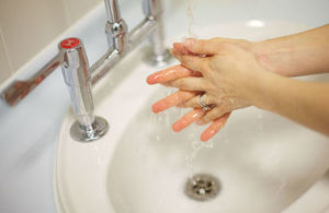 Hands being washed under running water.