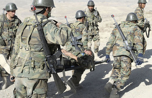 Afghan National Army Officer Candidate School students simulate evacuating an injured soldier during a field training exercise at Camp Alamo in Kabul, Afghanistan (stock image)