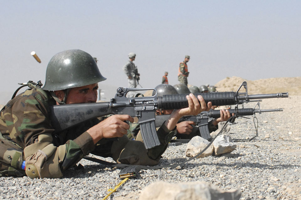 A member of the Officer Candidate School for the Afghan National Army learns basic rifle marksmanship on a range at Kabul Military Training Centre overseen by members of the US and British Armed Forces (stock image)