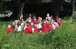 A class of children enjoy taking part in an outdoors learning session near their school