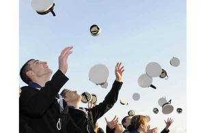 Sailors throw caps into the air