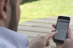 Man on bench signing up to eReminders on phone