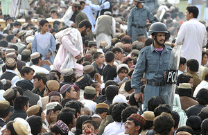 Afghan National Policemen maintain order in a 10,000-strong crowd attending a concert, held at Lashkar Gah stadium in celebration of the Afghan New Year