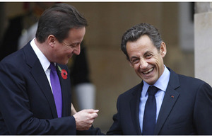 French President Nicolas Sarkozy (right) talks with British Prime Minister David Cameron as they arrive at Lancaster House in London