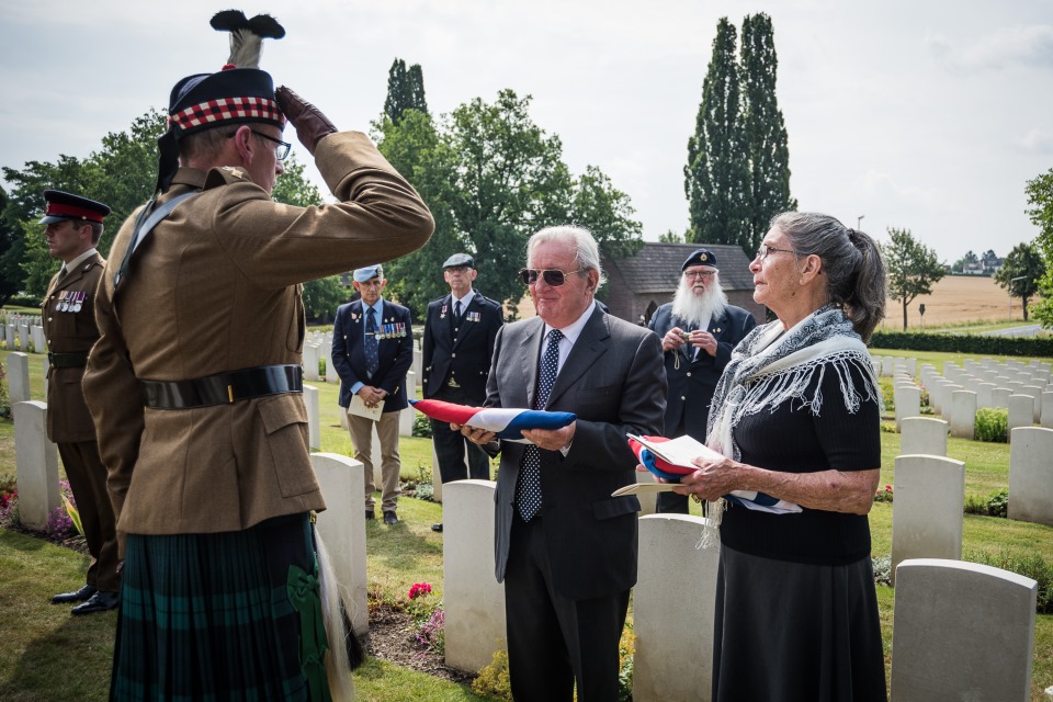 Tim Wadeson, son of Major Wadeson is presented with the Union Flag (Crown Copyright). All rights reserved