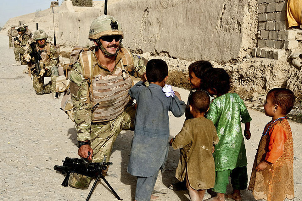 Royal Marines interact with Afghan children during a joint patrol with US Marines in Sangin 