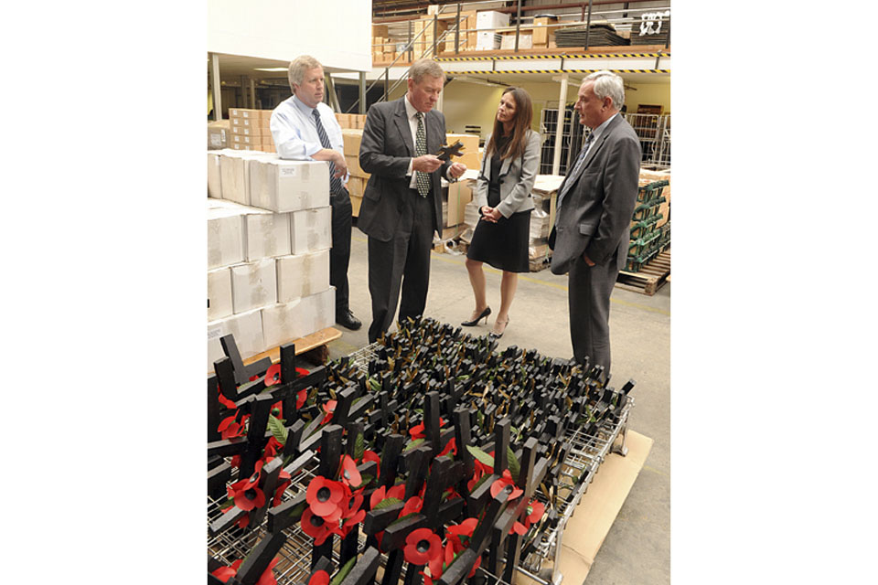 Minister for Defence Personnel, Welfare and Veterans, Andrew Robathan, in the Poppy Factory warehouse with the charity's Chief Executive, Melanie Waters 