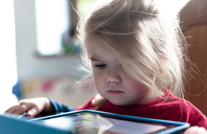 Child playing with a tablet.
